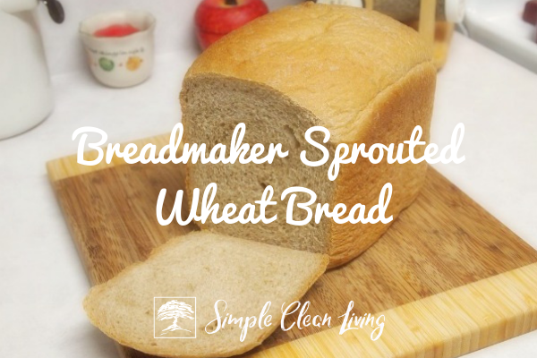 A picture of a loaf of sliced bread on a cutting board and the blog post title "Breadmaker Sprouted Wheat Bread"