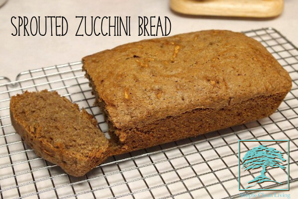 A fresh loaf of sprouted zucchini bread on a cooling rack