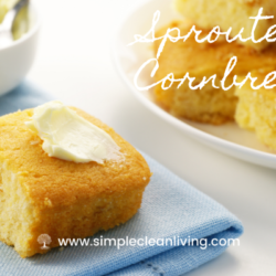 A plate piled with sprouted cornbread alongside a napkin with a piece of cornbread topped with butter