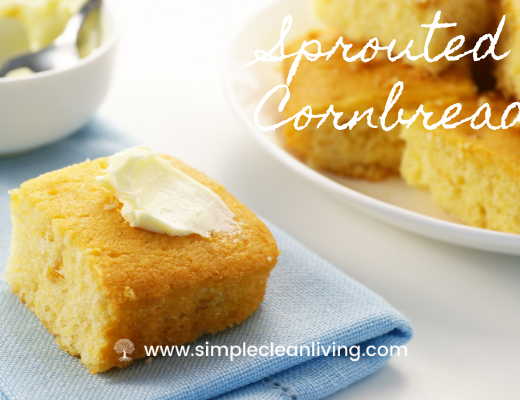 A plate piled with sprouted cornbread alongside a napkin with a piece of cornbread topped with butter