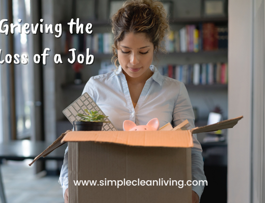 Grieving the Loss of Job Blog Post- A picture of a woman carrying a box of her things out of her office