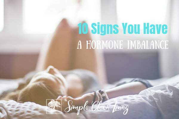 Picture of a woman laying on the bed with the blog post title "10 Signs You Have a Hormone Imbalance"