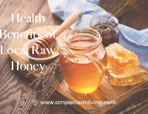 A jar of honey sitting on a cutting board