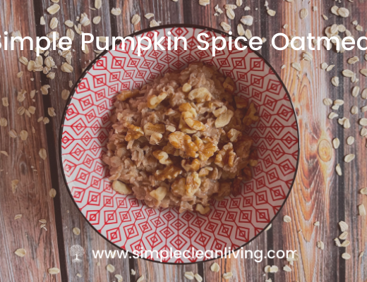 Bowl filled with pumpkin spice oatmeal topped with chopped walnuts