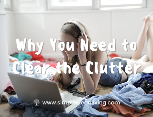Why You Need to Clear the Clutter blog post with a picture of a young woman working on her computer is a cluttered room