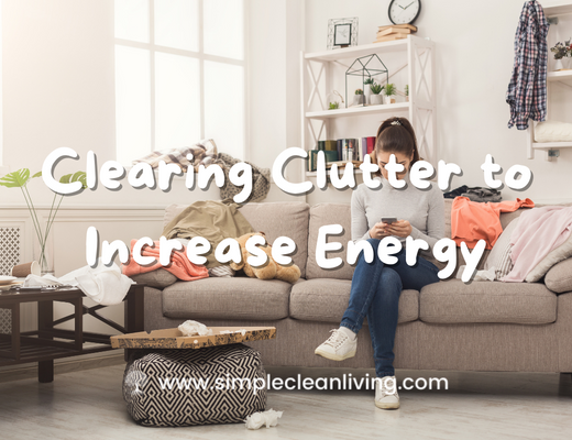 Clearing Clutter to Increase Energy blog post- Picture of a woman sitting on her couch in a very cluttered living room