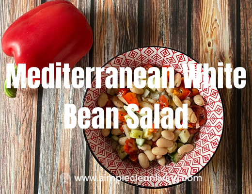 Mediterranean White Bean Salad Blog Post with a picture of a bowl of Mediterranean white bean salad on a table