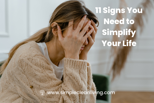 11 Signs You Need to Simplify Your Life- picture of woman holding her head in her hands looking stressed.