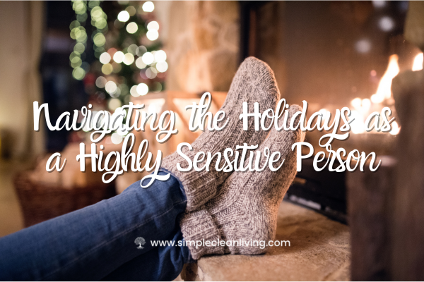 Navigating the Holidays as a Highly Sensitive Person blog post title with a picture of a woman sitting on the couch with her feet up. A christmas tree is in the background.