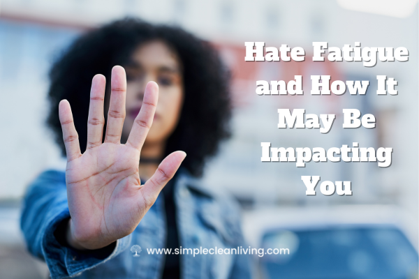 Hate fatigue and how it may be impacting you blog post title with picture of a woman holding her hand up in a "stop" pose