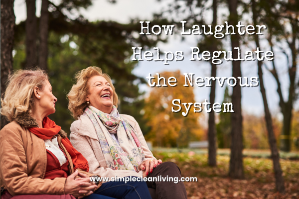 How Laughter Helps Regulate the Nervous System blog post title with a picture of two middle aged woman sitting on a bench in nature laughing.